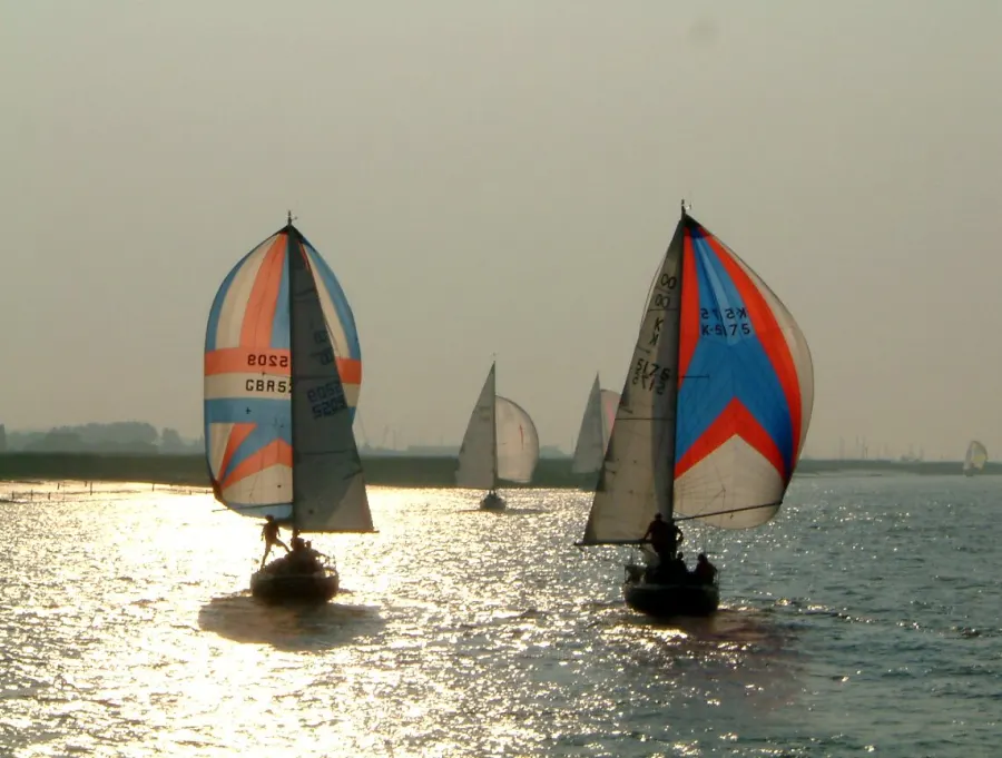 Yacht racing under spinnakers on the River Crouch, Burnham-on-Crouch, in Essex, England