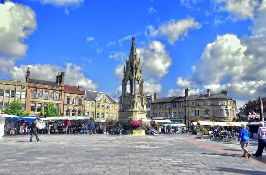 A bright morning for Mansfield's Tuesday market, showing the Bentinck Memorial in the centre of the picture.