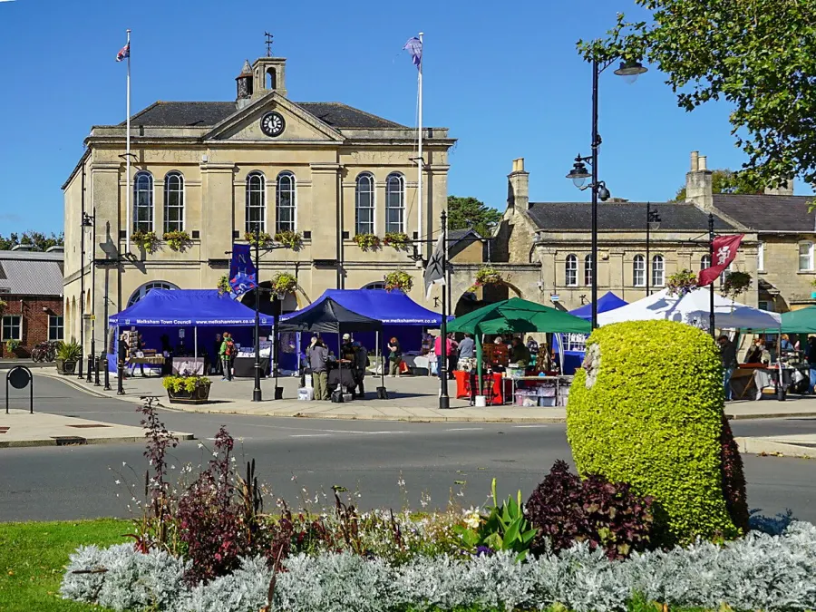 Melksham Makers' Market under way in front of the Town Hall, with a floral display in the foreground