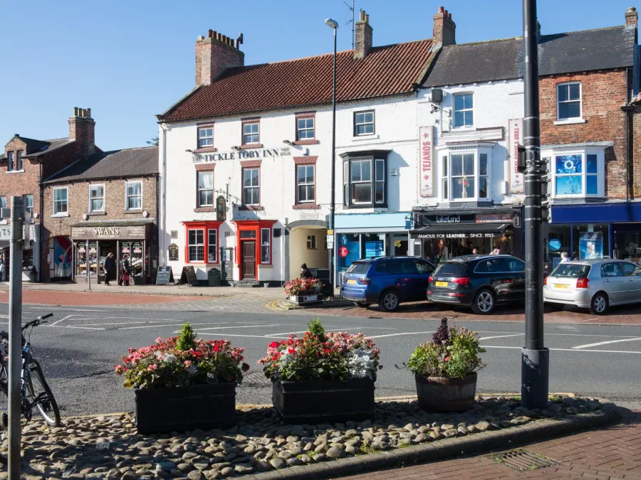 Shops beyond flower tubs in Northallerton 