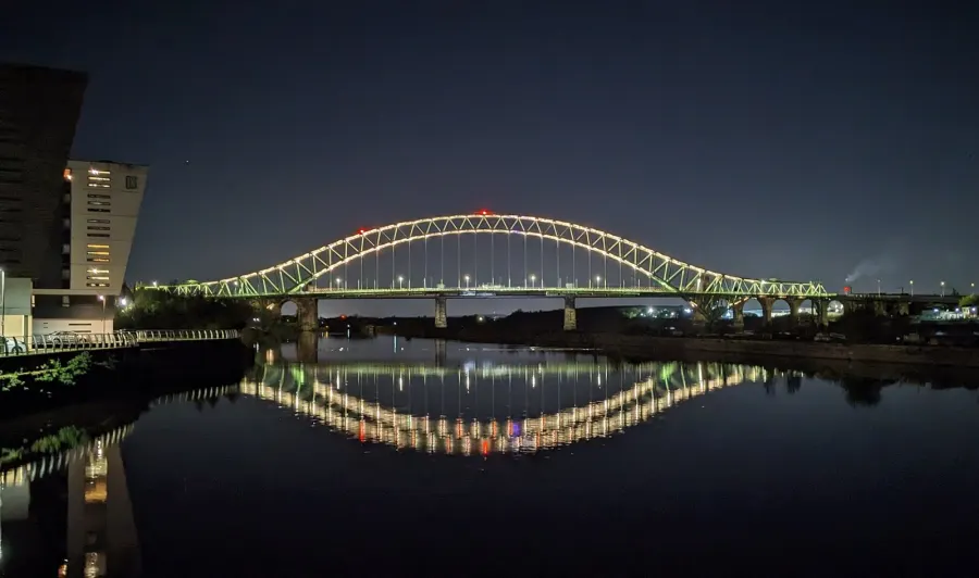 The Silver Jubilee Bridge, a through arch bridge, in Runcorn at night in 2024.